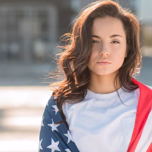 portrait-young-brunette-woman-holding-big-usa-flag_23-2148534449